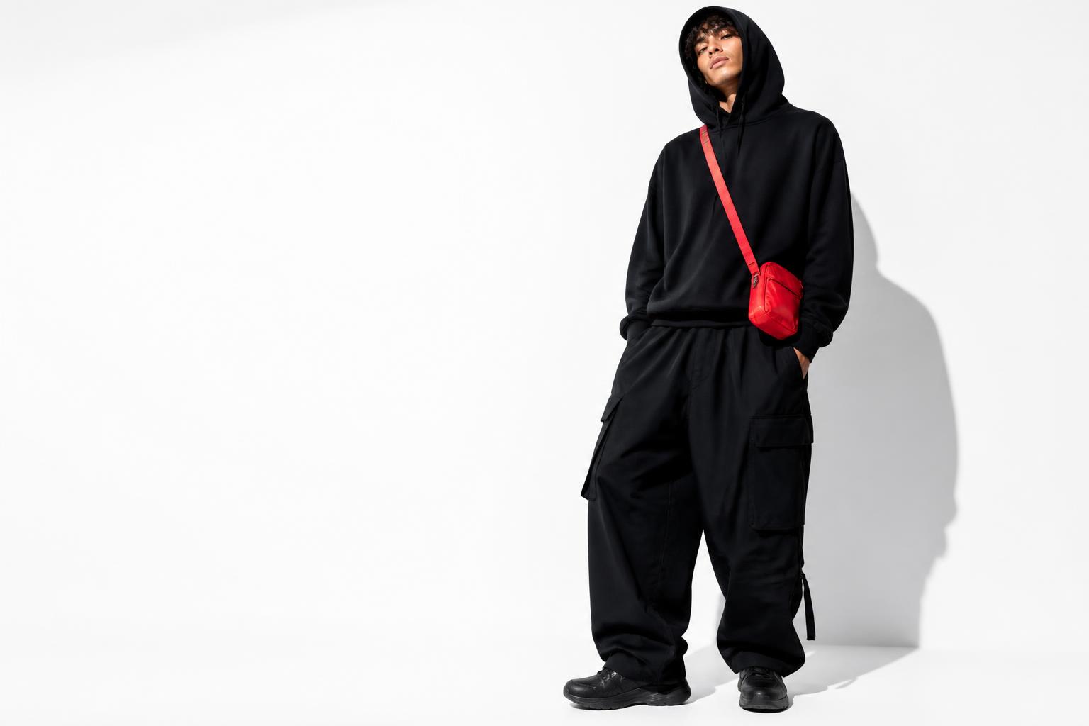RELOADED Drop 001 campaign — model wearing the Reloaded hoodie and wide cargo pants